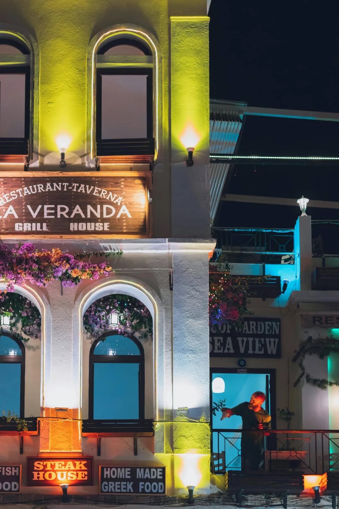 Colorfully Illuminated Restaurant Facade at Night in Rhodes, Greece
