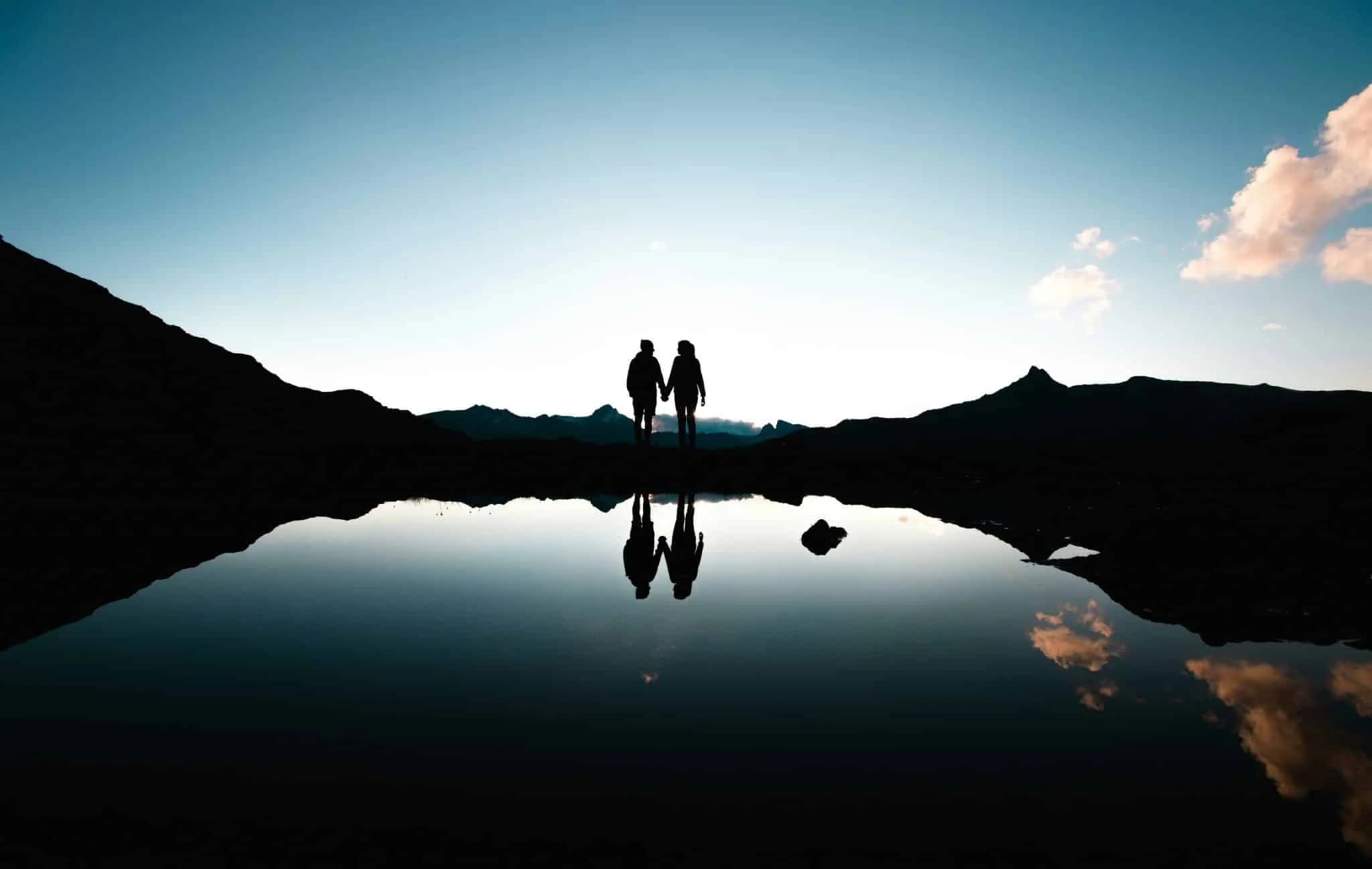Couple holding hands on Lake Grevas Alvas in Grisons in Switzerland