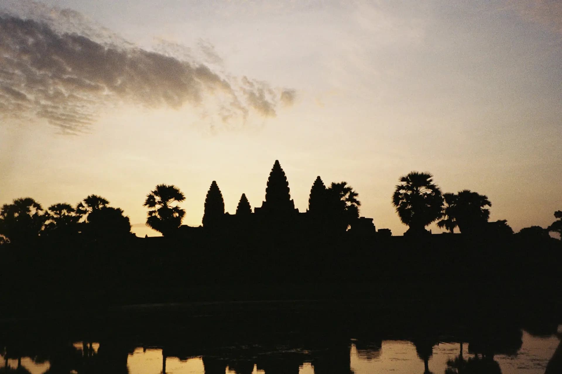Angkor Wat at sunrise — the five towers mirrored in the reflection pool
