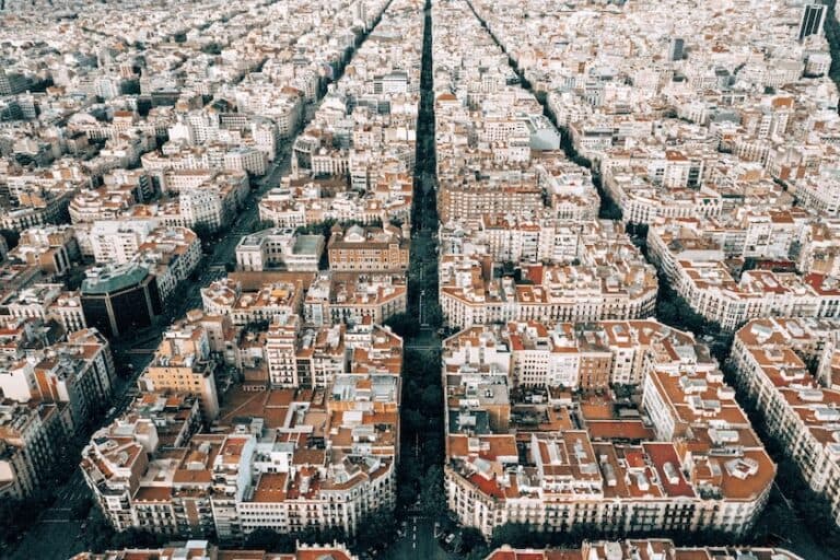 Aerial view of a city with grid-like streets and rows of red-tiled roofs, separated by a wide tree-lined avenue—perfect inspiration for your Spain Itinerary 10 Days adventure.