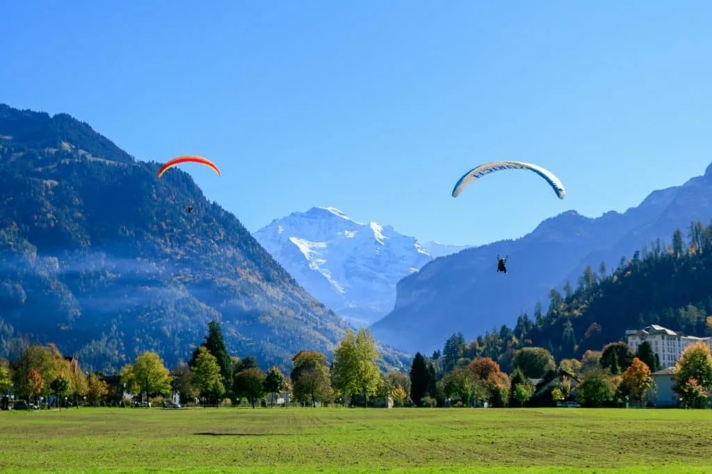 A peaceful view on 2 paragliders in Interlacken, Switzerland