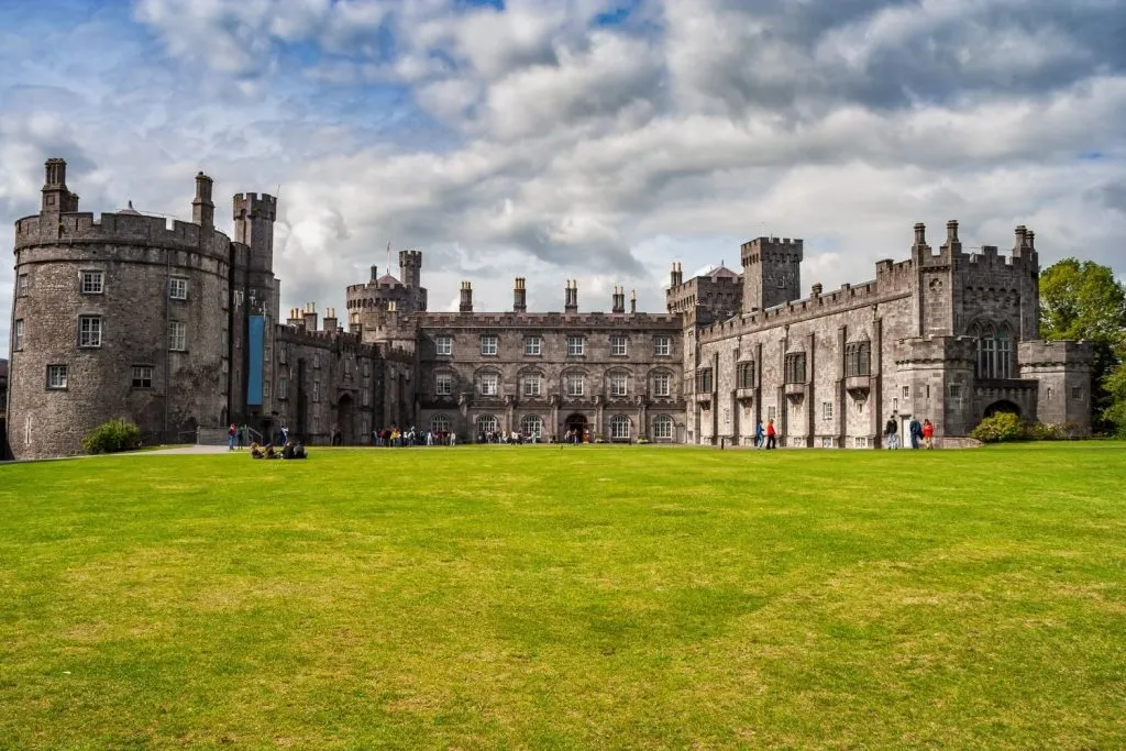 Kilkenny Castle with green grass and cloudy sky