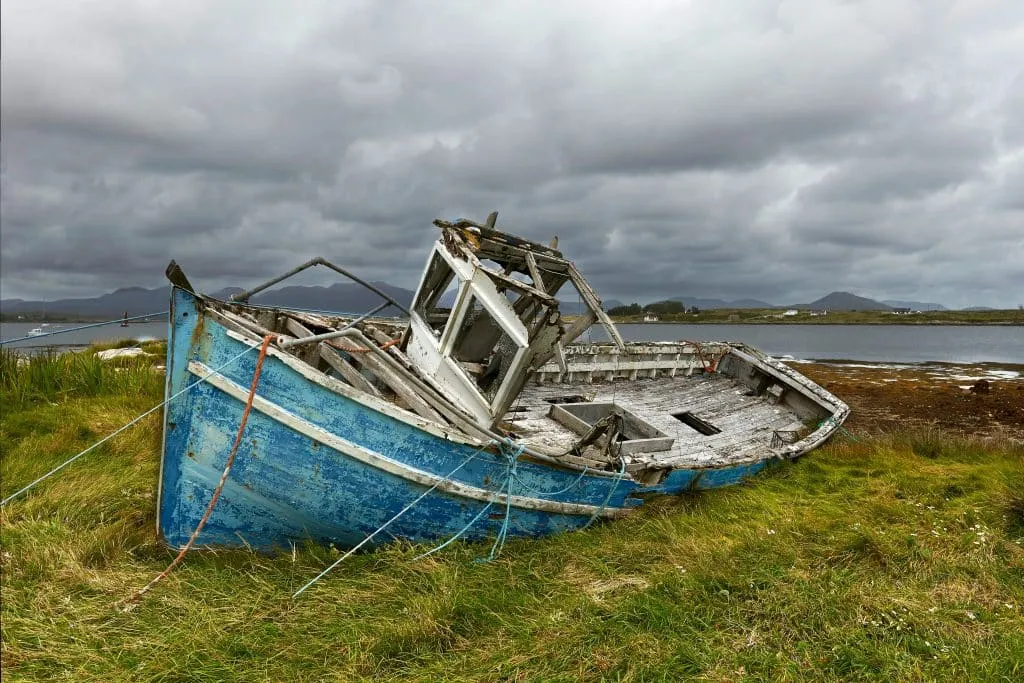 A derelict fishing boat on the shore at Roundstone, County Galway, Ireland