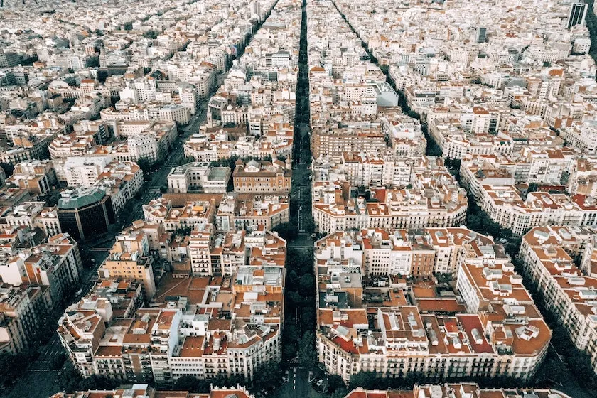 Aerial view of a city with grid-like streets and rows of red-tiled roofs, separated by a wide tree-lined avenue—perfect inspiration for your Spain Itinerary 10 Days adventure.
