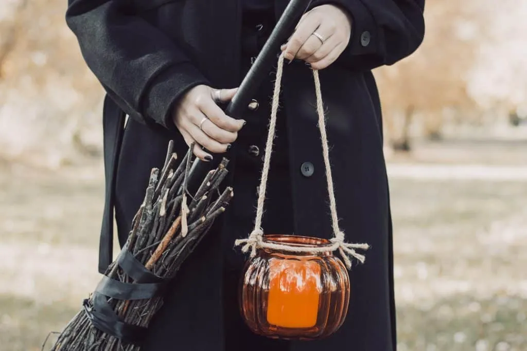 Witch holding broom and Candle