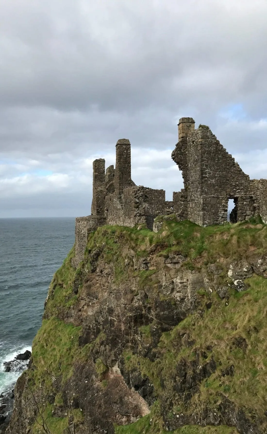 The ruins of Dunluce Castle on a clifftop above the sea on the north Antrim coast.