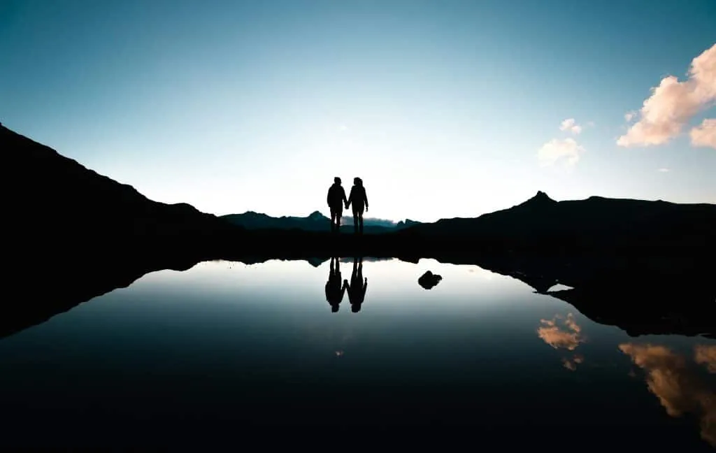 Couple holding hands on Lake Grevas Alvas in Grisons in Switzerland