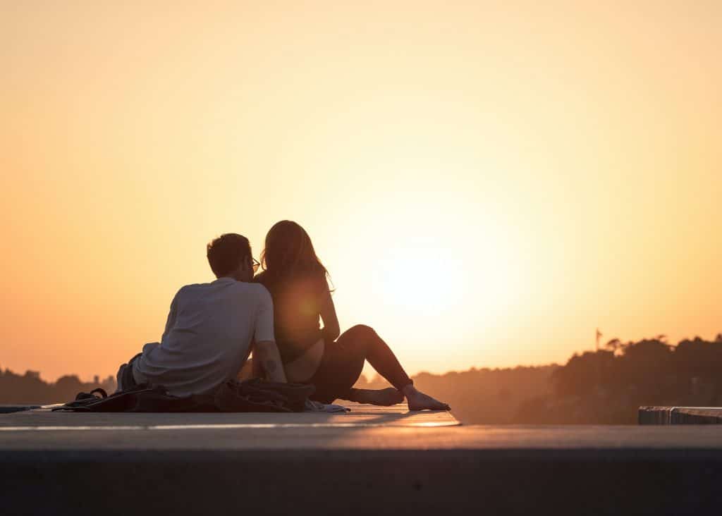 Couple relaxing by sunset