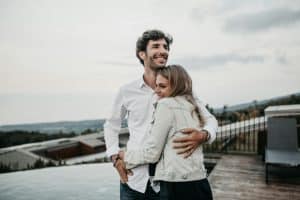 Couple hugging with out of focus background