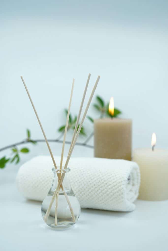 Essenital oils, candles, and towels within a spa setting