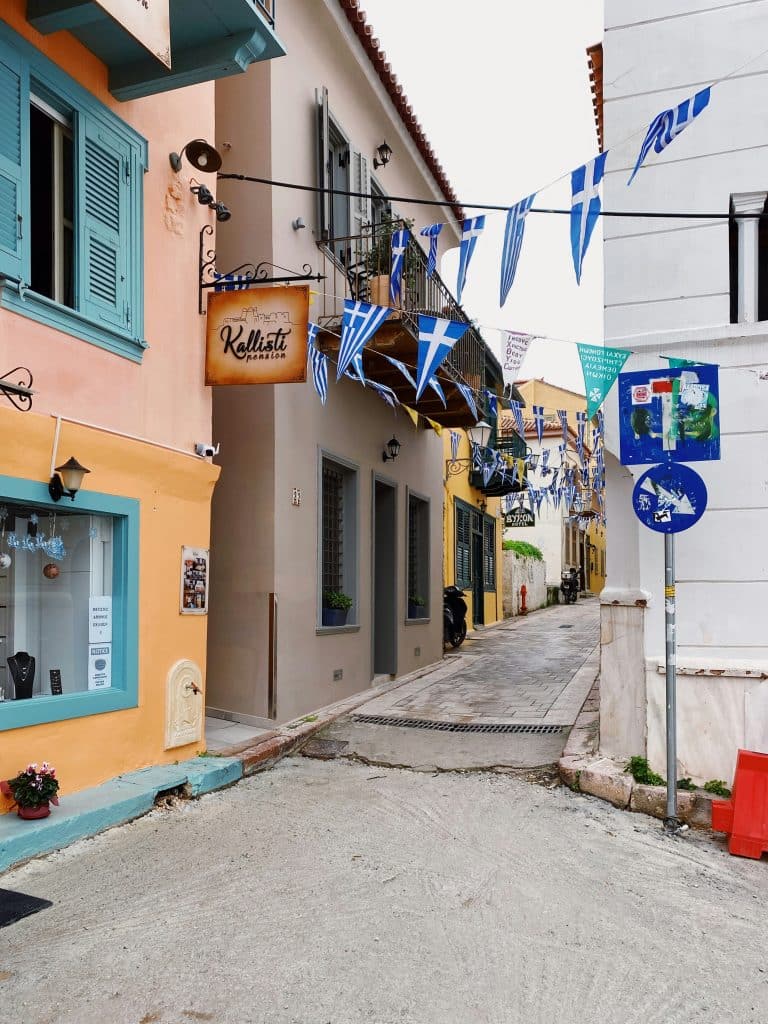 Greek Flags hung from building to building on a street in a Greek town