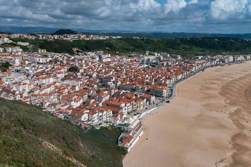 Aerial View of City Buildings on Green Grass Field Nazaré, Leiria District, Portugal